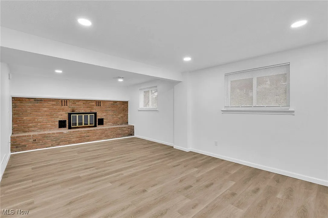Finished basement with brick fireplace