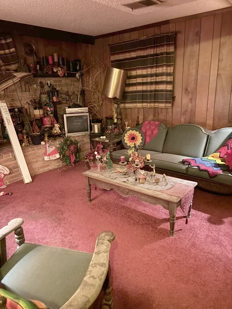 Living room as purchased, red carpet and wood panelling