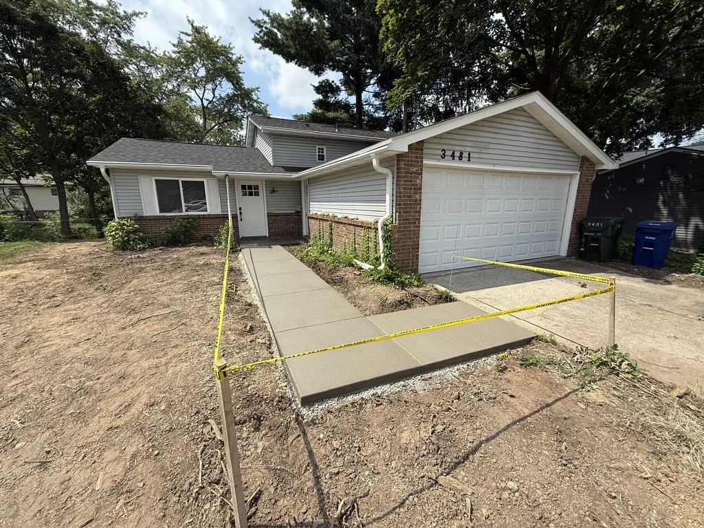Freshly poured driveway apron and front walk
